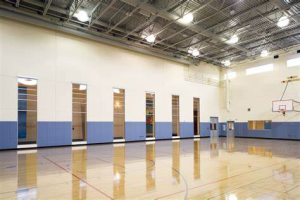 Indoor gymnasium with basket ball hoop and court